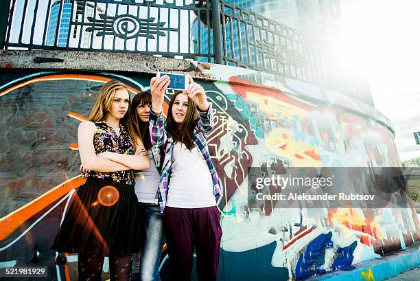 friends taking selfie, mural in background - photographing graffiti stock pictures, royalty-free photos & images