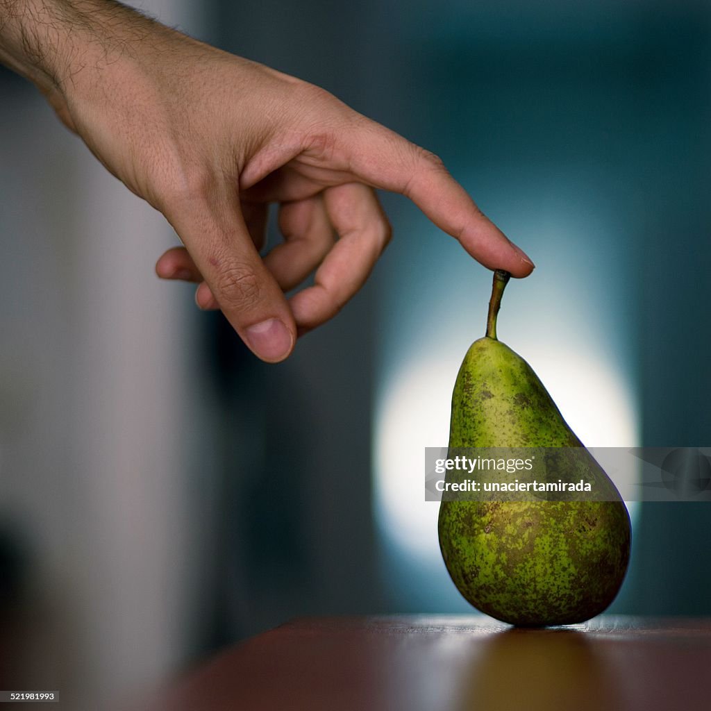 Man touching a pear