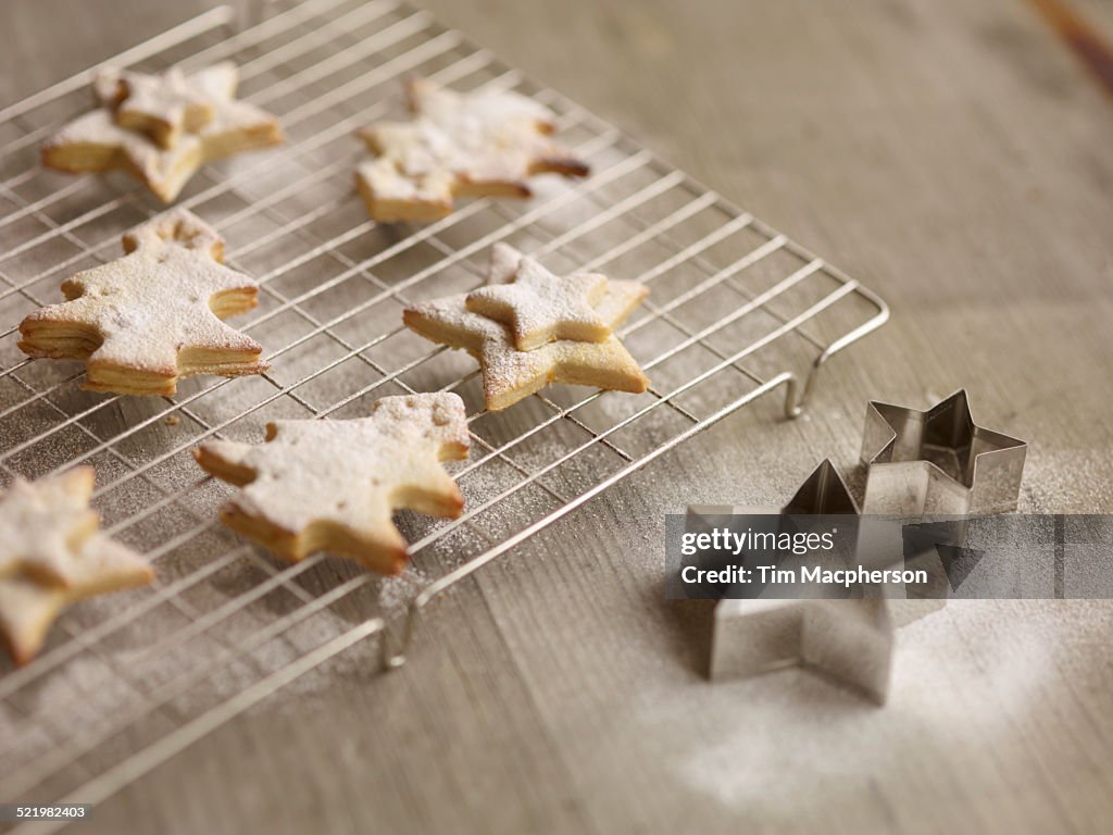 Close up of freshly baked christmas biscuits on cooling rack