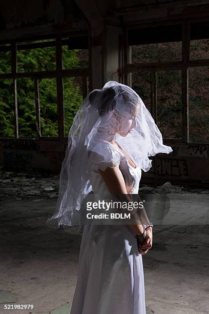 portrait of bride in empty abandoned interior - nervous bride stock pictures, royalty-free photos & images