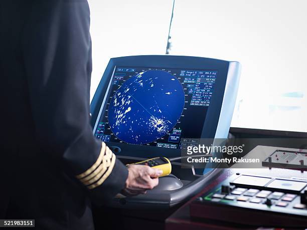 ships captain working on bridge with radar screen, close up - ship captain stock pictures, royalty-free photos & images