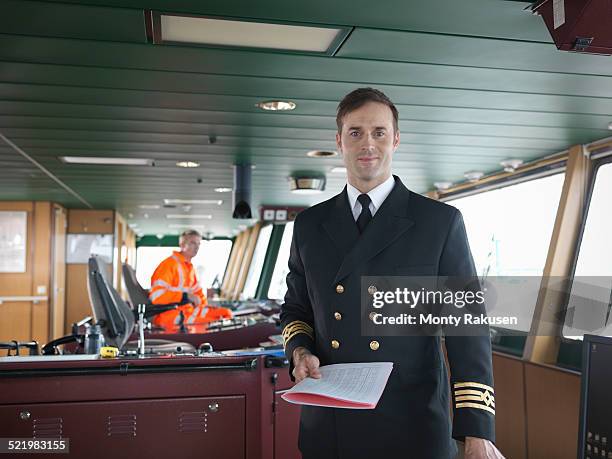 portrait of captain on bridge of ship - ship captain stock pictures, royalty-free photos & images