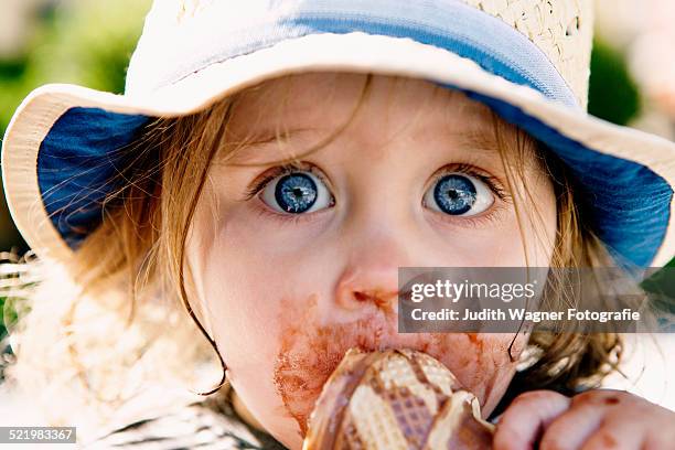 young girl eating ice cream cone - girl eating messy ice cream cone stock-fotos und bilder