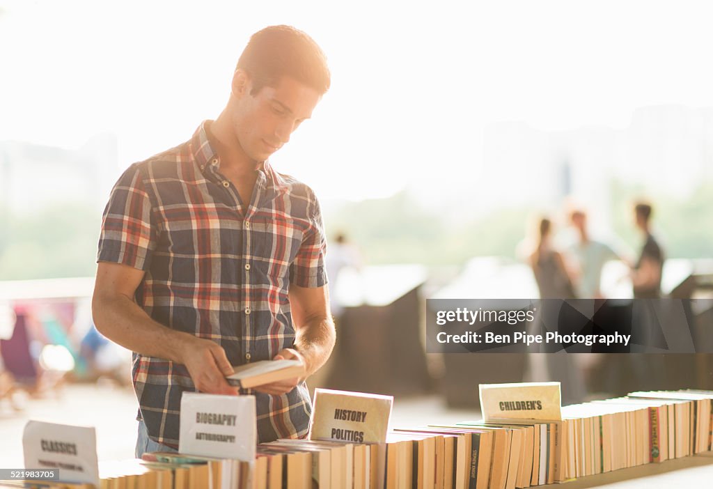 Young man at second hand book stall