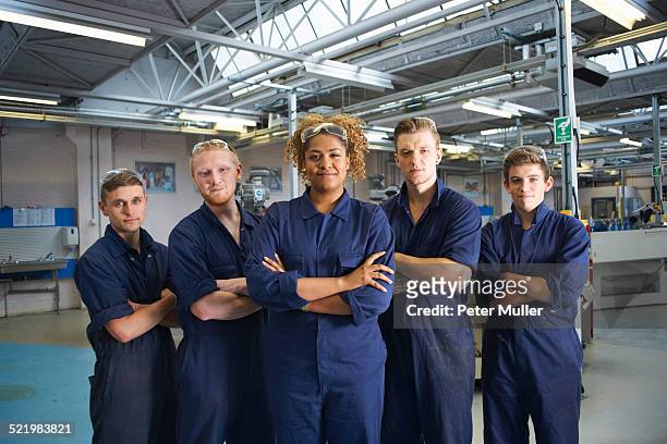 group portrait of students in college workshop - overalls stock pictures, royalty-free photos & images