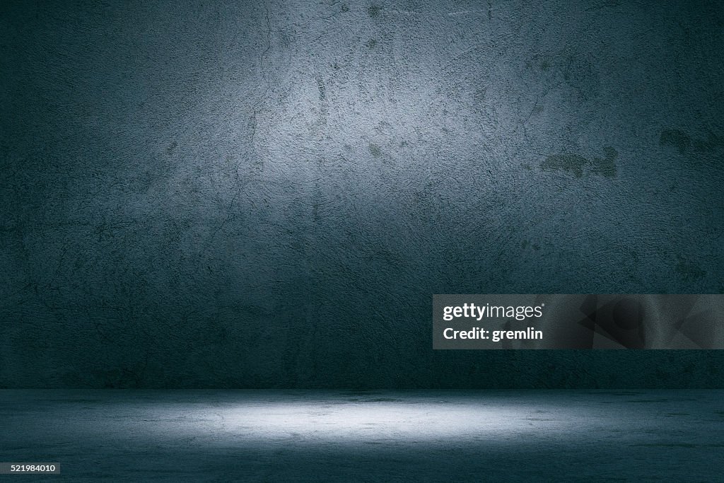 Empty spotlit concrete background