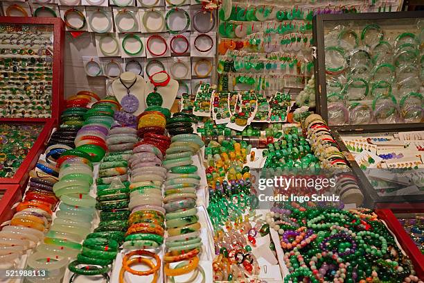 various pieces of jewelry made of jade in the jade market, kowloon, hong kong, china - bangle stock pictures, royalty-free photos & images