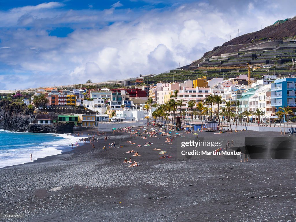 Tourists on the black beach of Puerto Naos, La Palma, Canary Islands, Spain