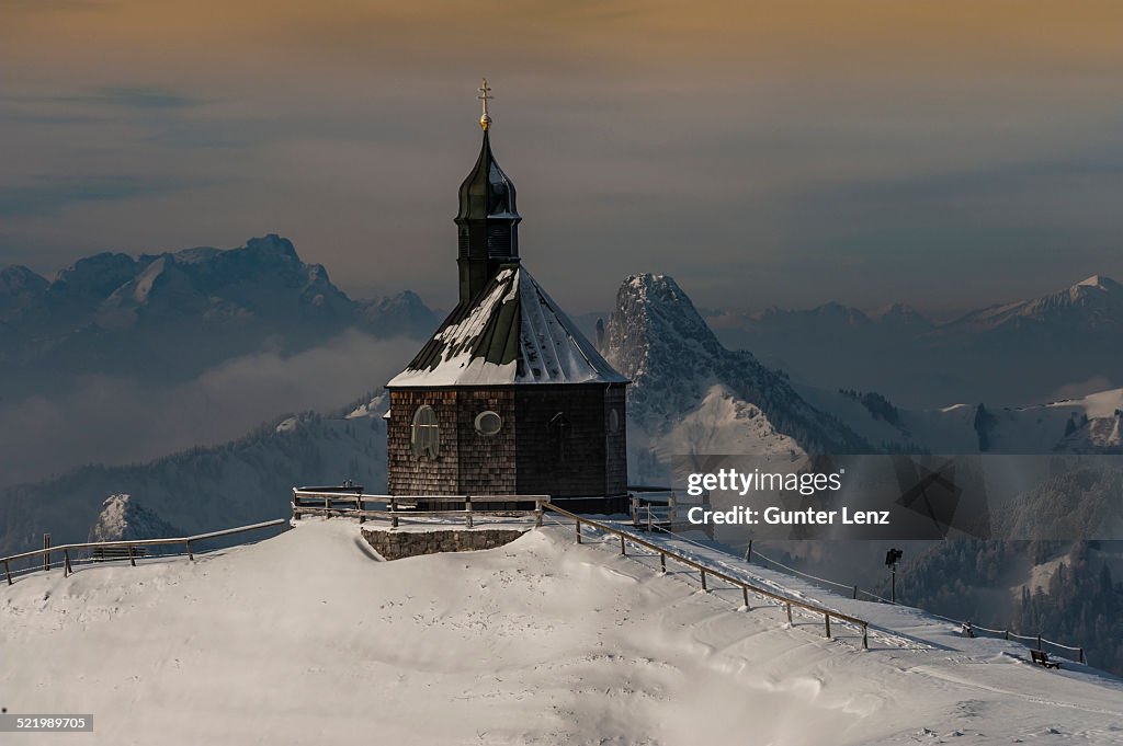 Wallbergkircherl on Mt. Wallenberg in winter, rear left Zugspitze, and Rossstein and Buchstein right, Upper Bavaria, Bavaria, Germany