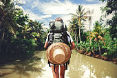 Woman standing near big tropical river
