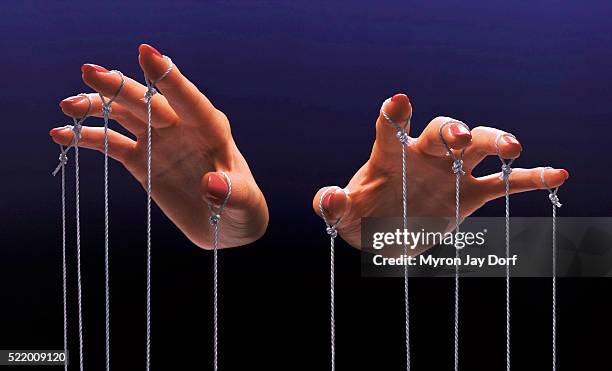 fingers of a puppeteer - controlling stock-fotos und bilder