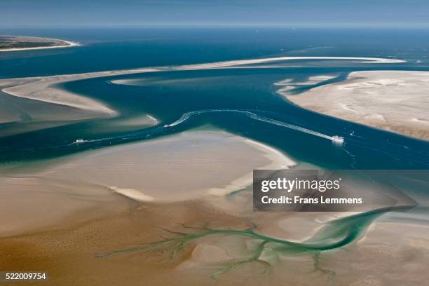 netherlands, island terschelling, group of islands called wadden sea. low tide. ferryboat. unesco world heritage site. aerial. - mar de wadden fotografías e imágenes de stock