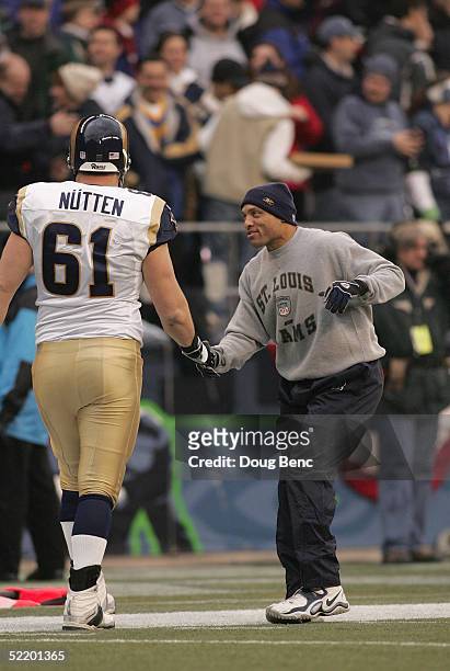 Injured free safety Aneas Williams of the St. Louis Rams celebrates with his teammate Tom Nutten during the National Football Conference wild-card...