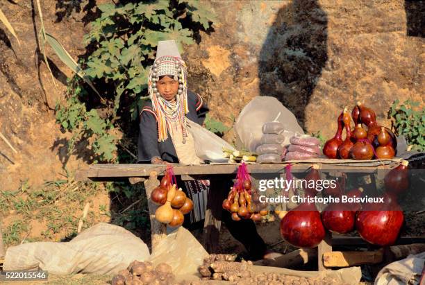 akha street vendor selling gourd containers - akha woman stock pictures, royalty-free photos & images