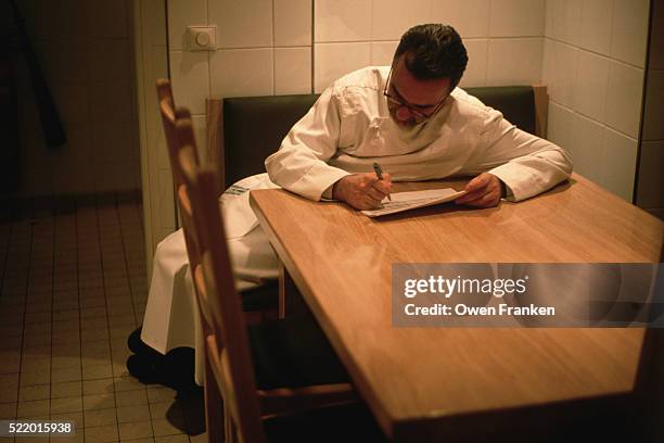 chef alain ducasse going over menu - alain ducasse stock-fotos und bilder