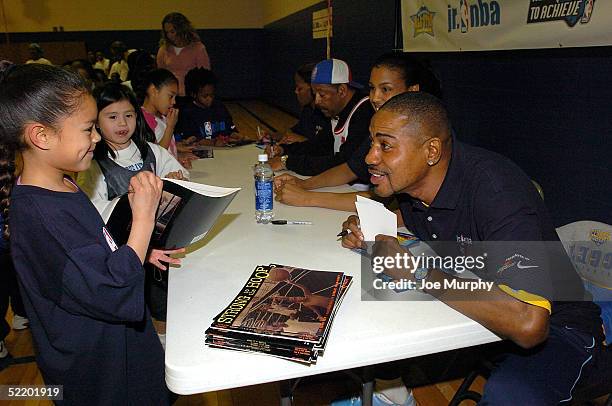 Denver Nuggets legend Micheal Ray Richardson signs autographs for kids at Glenarm Recreation Center on February 15, 2005 in Denver, Colorado. NOTE TO...