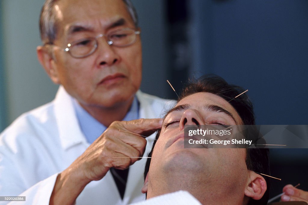 Acupuncturist with a patient