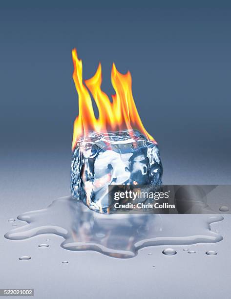 block of ice on fire - water puddle stock pictures, royalty-free photos & images