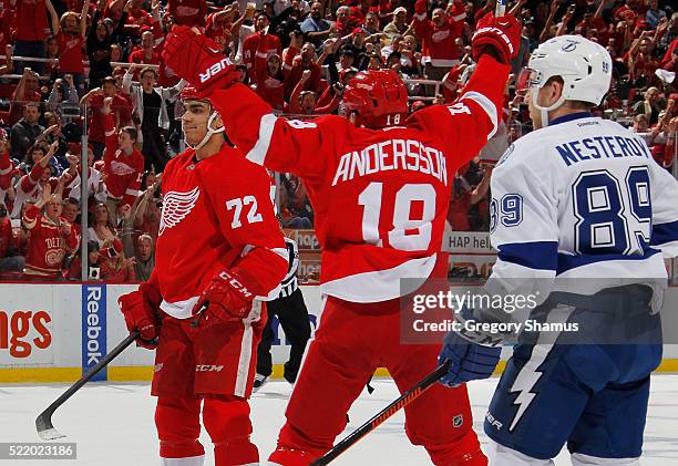 Andreas Athanasiou of the Detroit Red Wings celebrates his second period goal with Joakim Andersson while playing the Tampa Bay Lightning in Game...