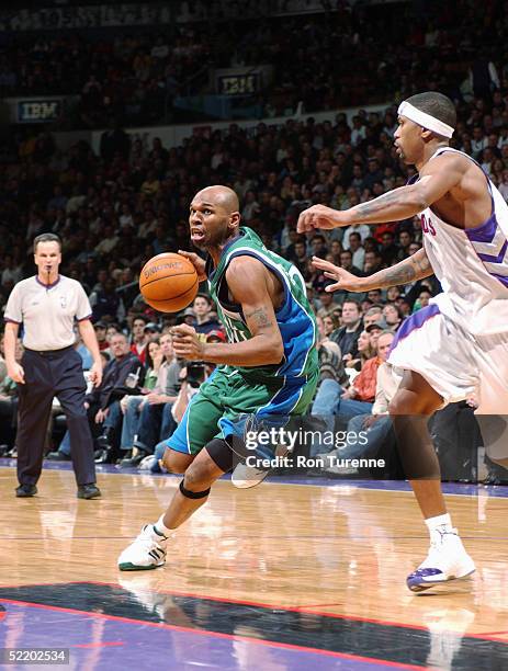 Jerry Stackhouse of the Dallas Mavericks drives around Jalen Rose of the Toronto Raptors during the game at Air Canada Centre on February 6, 2005 in...