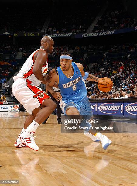 Kenyon Martin of the Denver Nuggets drives off the wing against Antoine Walker of the Atlanta Hawks on February 15, 2005 at Philips Arena in Atlanta,...