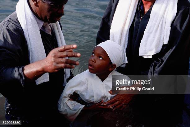 boy getting baptized in louisiana - black baptism stock pictures, royalty-free photos & images