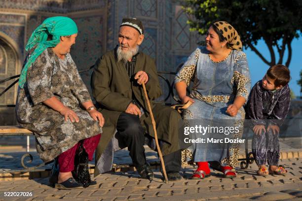 pilgrims in front of the ulugh beg madrasah in samarkand - uzbekistan stock pictures, royalty-free photos & images