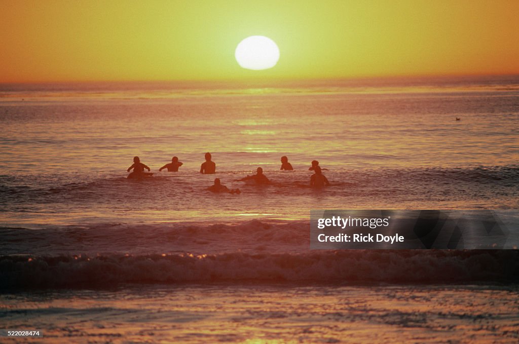 Surfers Enjoying the Sunset
