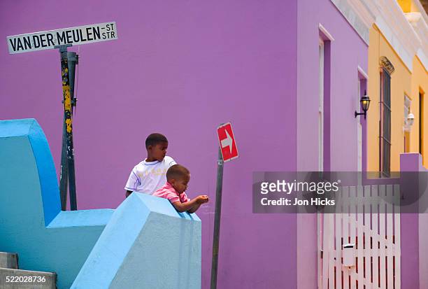 boys among colorful houses in bo kaap - cape town bo kaap stock pictures, royalty-free photos & images