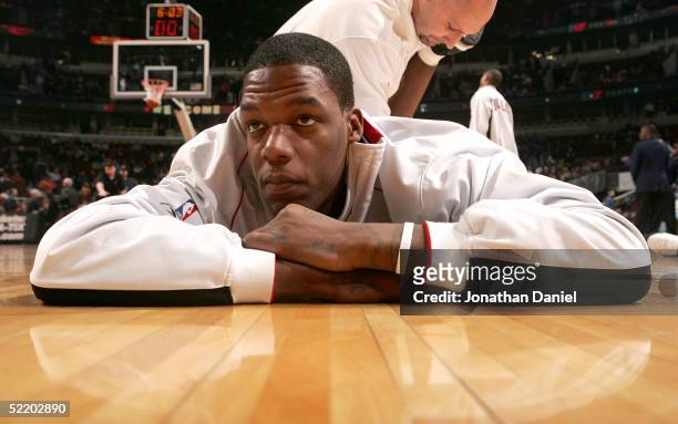 Eddy Curry of the Chicago Bulls relaxes as he is stretched before a game against the Sacramento Kings on February 15, 2005 at the United Center in...