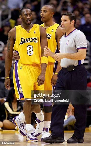 Caron Butler holds back teammate Kobe Bryant of the Los Angeles Lakers after Bryant received a technical foul during the game against the Utah Jazz...