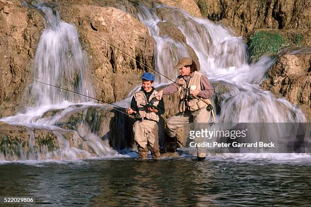 mother and son fly fly fishing - waders imagens e fotografias de stock