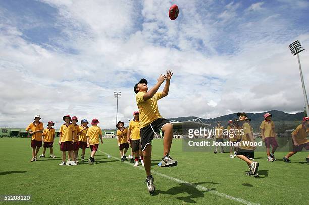 Junior participants practice their marking technique during the AFL Melbourne Community Camp at Cazalys Stadium February 16, 2005 in Cairns,...