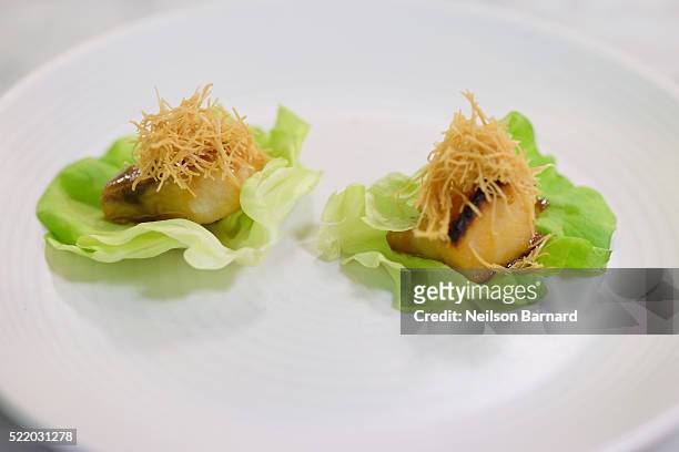 View of black cod on butter lettuce finished dish during Chefs Taku Sato and Ricky Estrellado's Nobu Classics class at The 8th Annual New York...