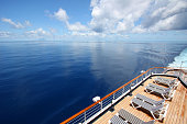 Cruise ship sails across a beautiful calm ocean.