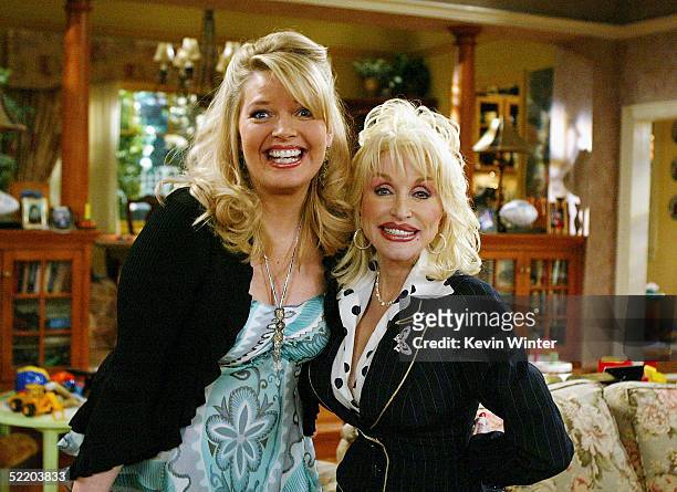 Actress Melissa Peterman and singer Dolly Parton pose on the set of The WB's "Reba" at 20th Century Fox Studios on February 15, 2005 in Los Angeles,...
