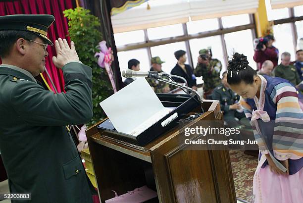 Graduate, Lee Na-Young is saluted by a South Korean military general during a graduation ceremony for two students at Taesungdong Elementary School...
