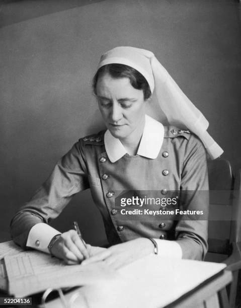 Canadian nurse Matron Dunn attends to her paperwork,at a Red Cross hospital near London, October 1940.