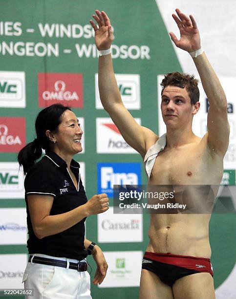 Vincent Riendeau of Canada is congratulated by coach Yihua Li and waves to the crowd after competing in the Men's 10m Final during Day Three of the...