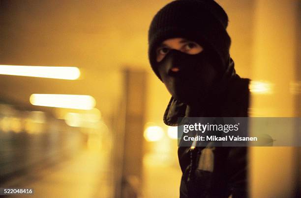 a masked man who is laying wait - bivakmuts stockfoto's en -beelden