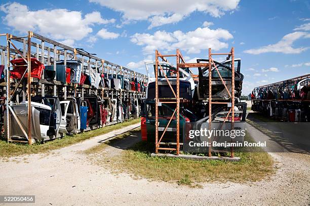 old car parts on racks - junkyard stock pictures, royalty-free photos & images