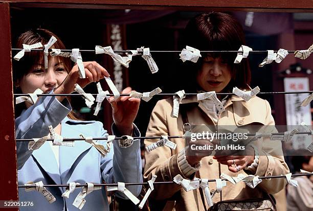 women praying at yasaka jinja temple - yasaka shrine stock pictures, royalty-free photos & images