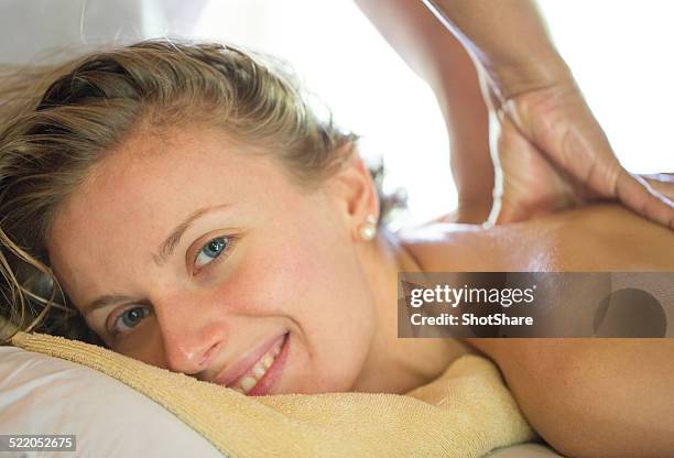 woman have a massage - woman back pillow blonde stock pictures, royalty-free photos & images