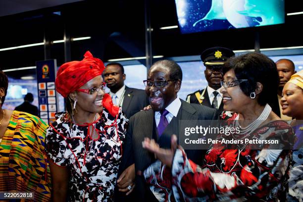 Zimbabwean president Robert Mugabe with his wife Grace Mugabe and Winnie Mandela in the presidential suite during the final of Africa's Cup at Soccer...