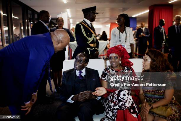 Zimbabwean president Robert Mugabe with his wife Grace Mugabe chats with other dignitaries in the presidential suite during the final of Africa's Cup...