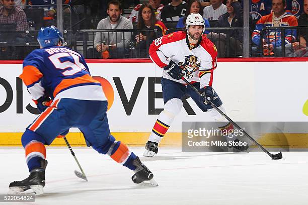Jaromir Jagr of the Florida Panthers plays the puck against Johnny Boychuk of the New York Islanders in Game Three of the Eastern Conference...