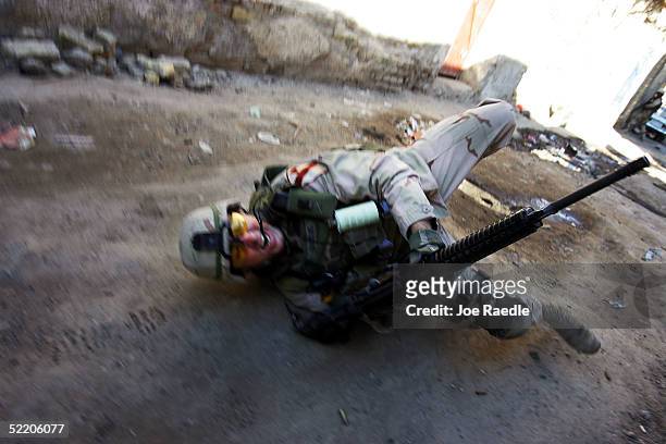 Army Sergeant 1st Class Troy Hawkins of the 1st Cavalry, Task Force 1-9, falls to the ground after being wounded during a firefight while on patrol...