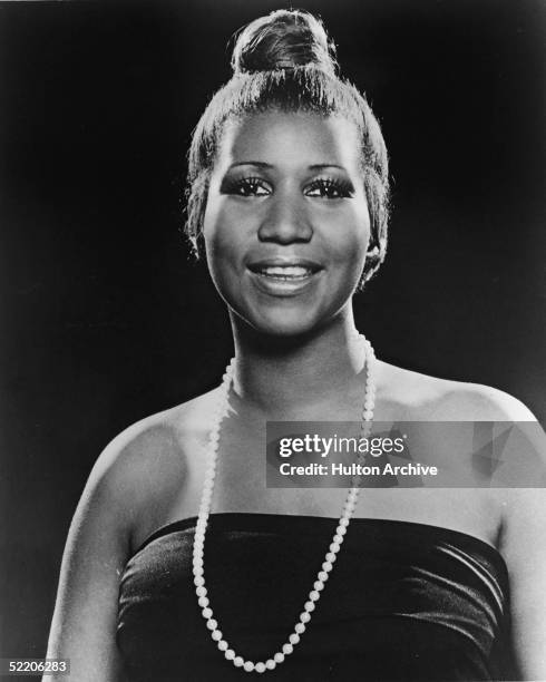 Portrait of American soul singer Aretha Franklin as she wears a strapless dress and pearl necklace and has her hair in a bun, 1977.