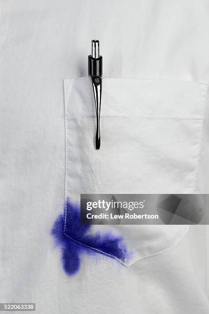 close up of white shirt with blue ink stain on pocket - stained shirt stock pictures, royalty-free photos & images