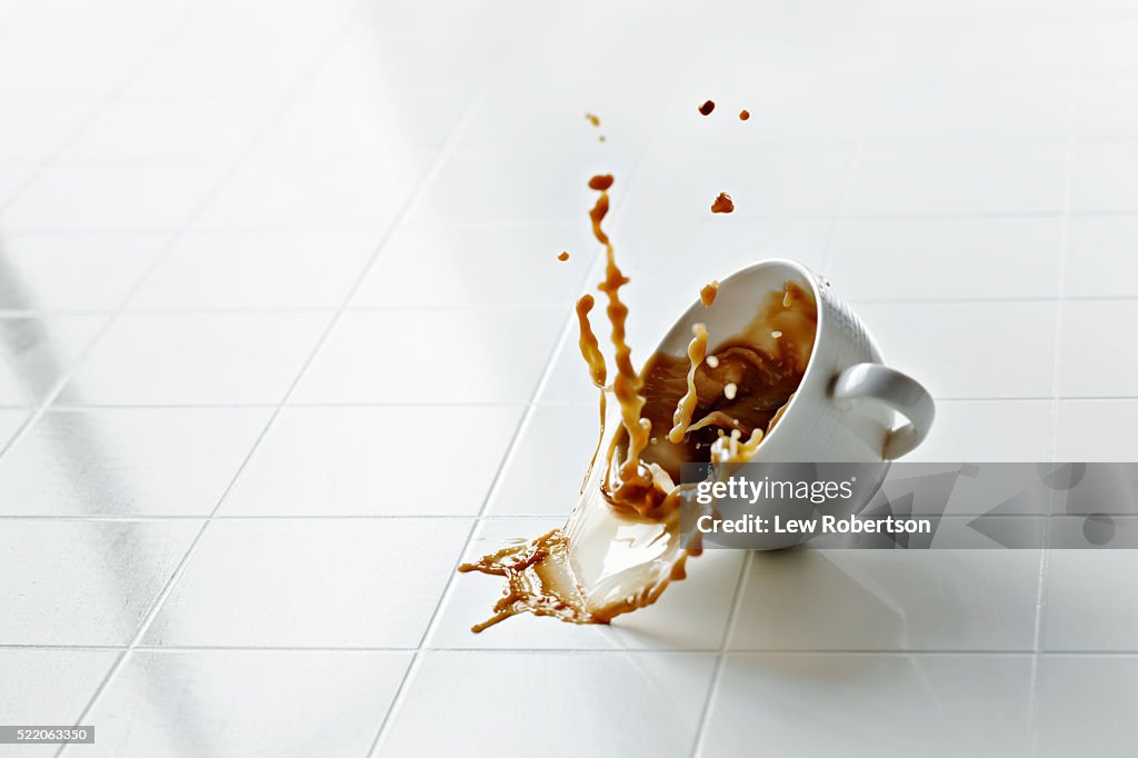 Coffee cup in mid air with coffee spilling